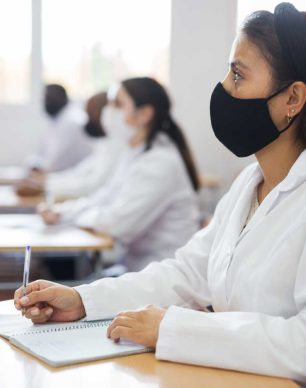 Students in lab coats during CliniWings classroom session